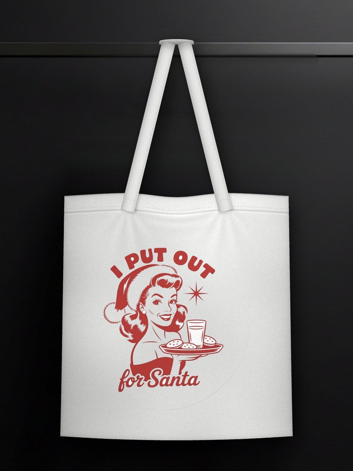 White tote bag with a retro I Put Out for Santa print